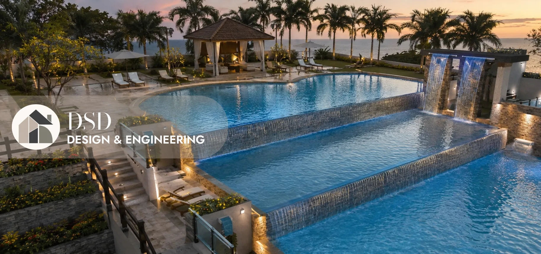 Oceanfront infinity pool with cascading waterfalls at sunset